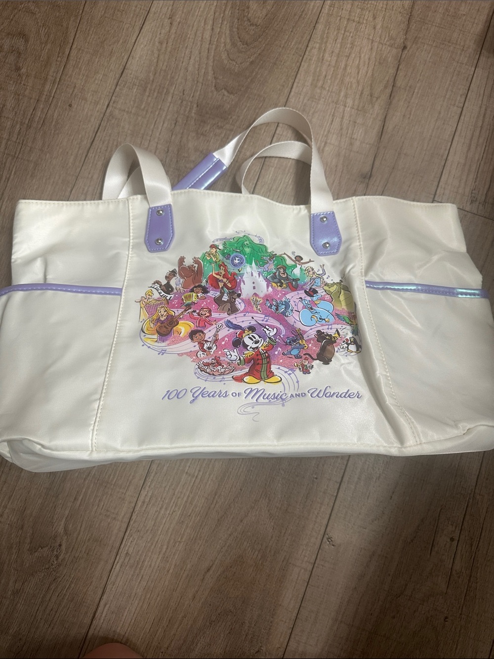 Disney White Tote with Colorful Character Collage and iridescent Purple Accents.